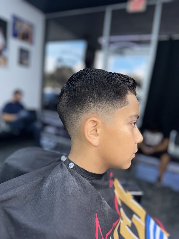 Young client with a neat comb-over and taper fade