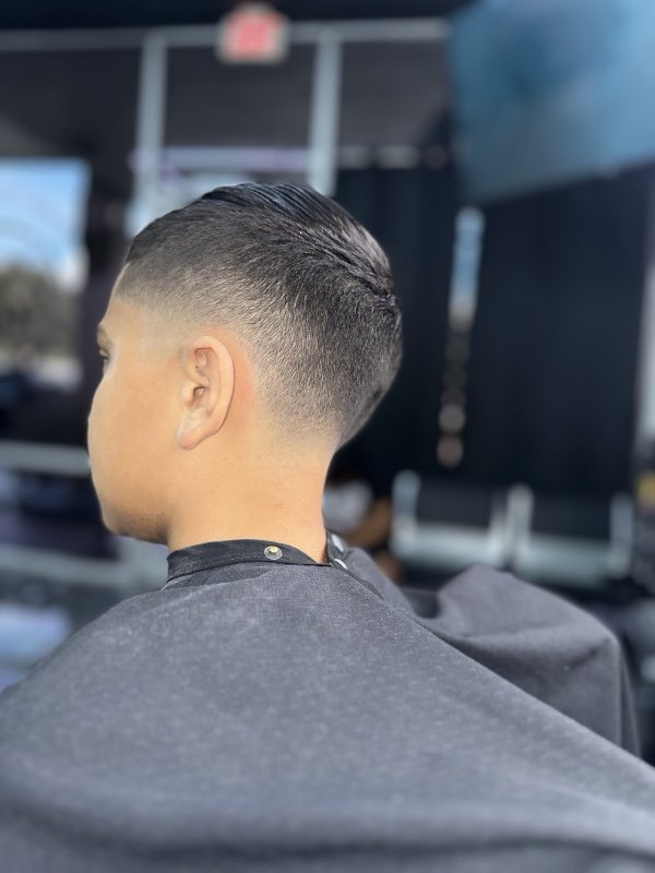 Clean fresh fade with a slicked-back top, back view
