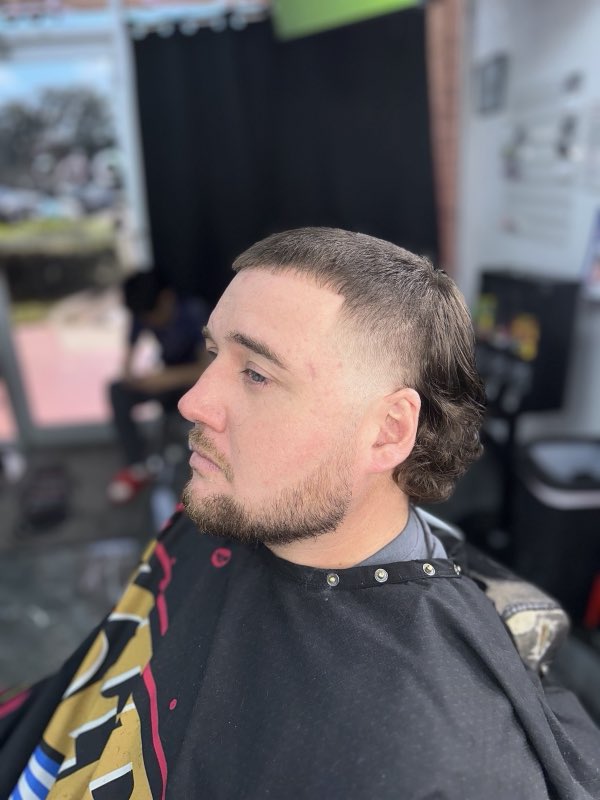 Taper fade blended into a shaped beard